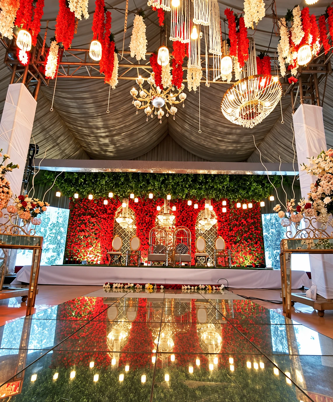 Red rose floral wall stage with hanging lanterns and chandeliers