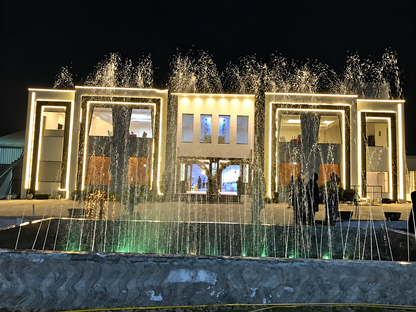 Musical fountain display in front of the illuminated marquee