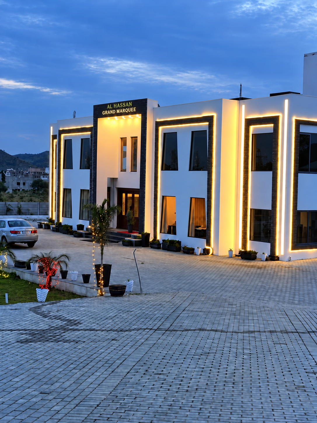 Al Hassan Grand Marquee building at dusk with warm LED outline lighting