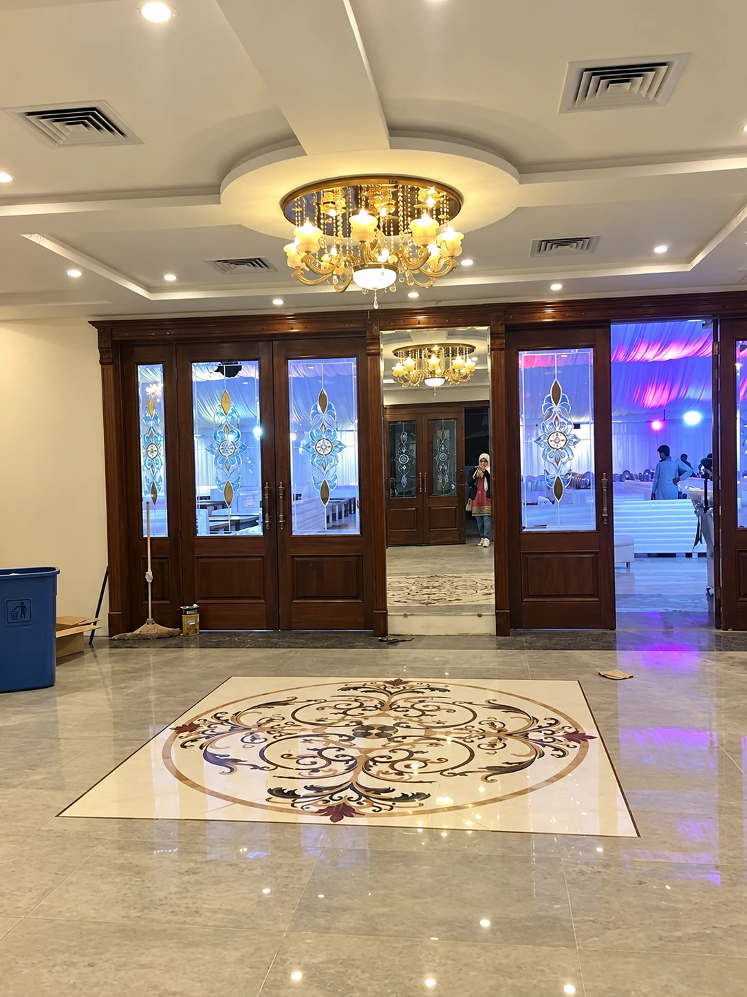 Venue lobby with crystal chandelier and inlaid marble floor medallion